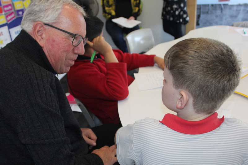 Murray interacting with students during the writing process.